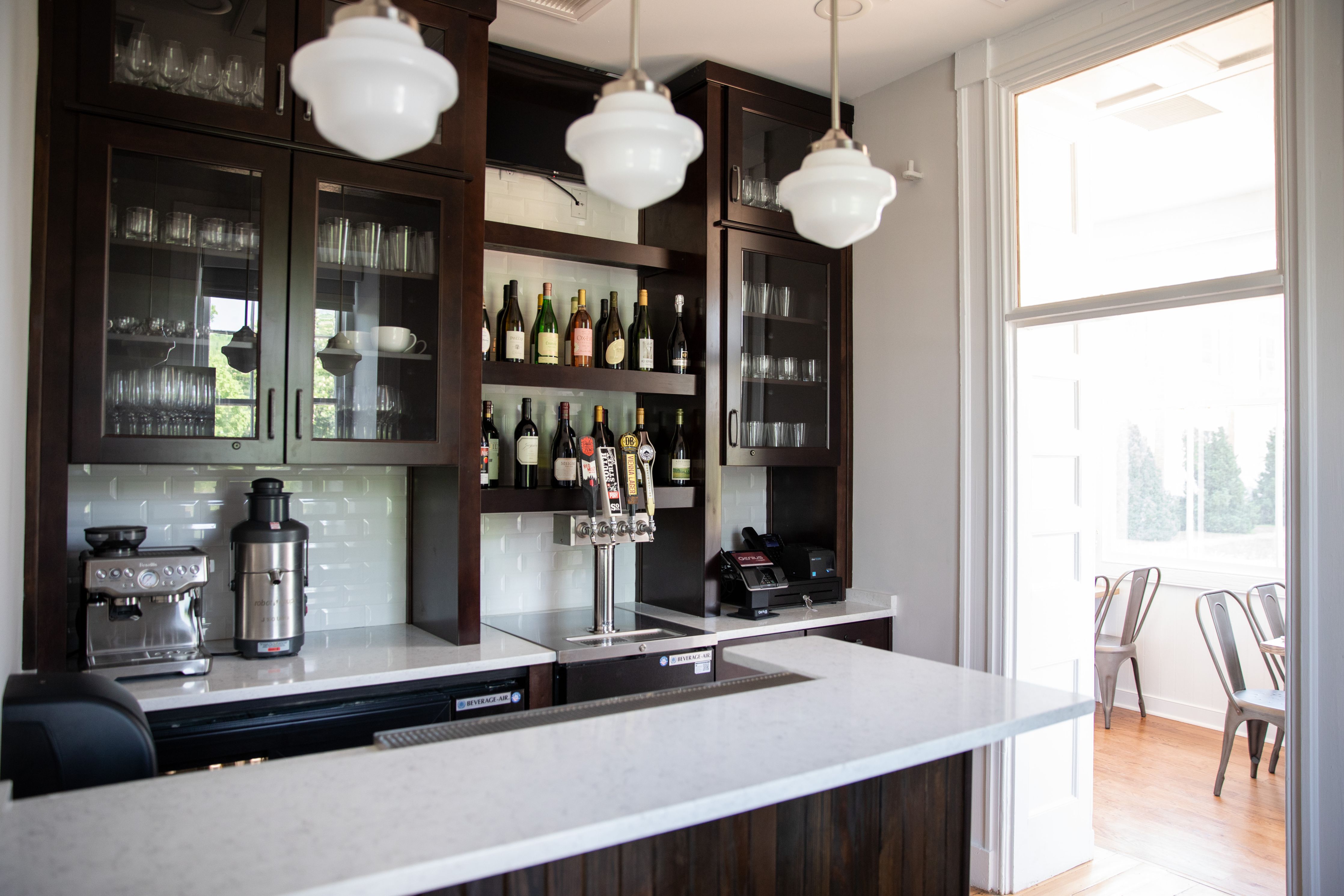 a bar with a counter and bottles of liquor