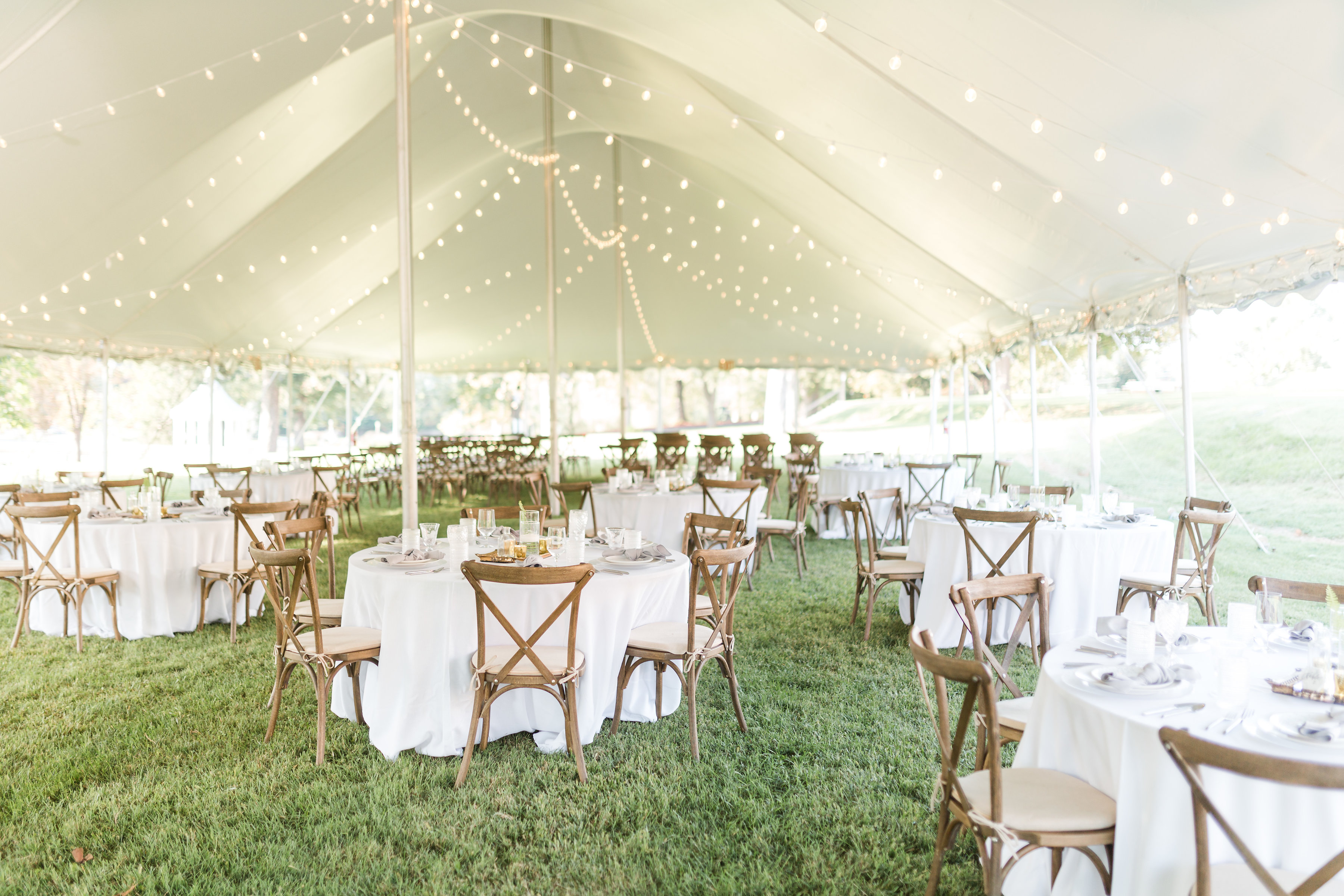 a white tent with tables and chairs