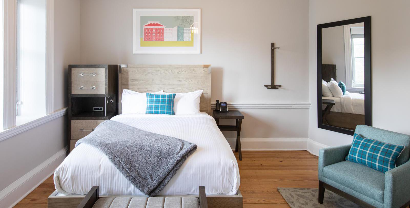 a bed with a blanket and a pillow in a room