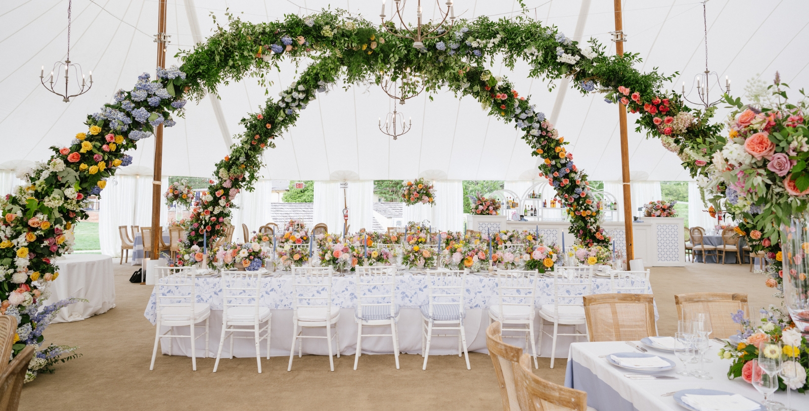 a table set up with flowers and chairs