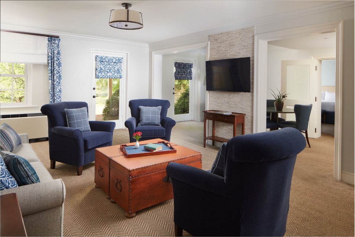 a living room with blue chairs and a coffee table