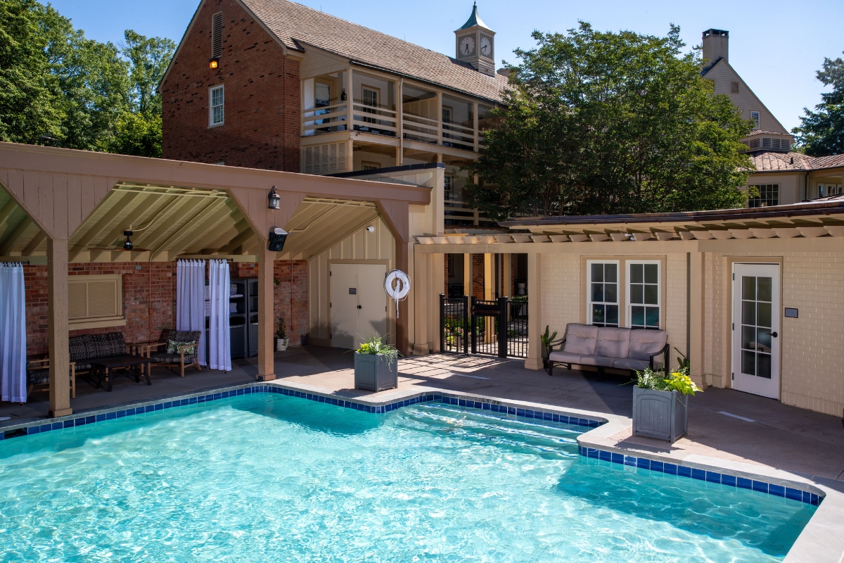 a swimming pool with a house and a building