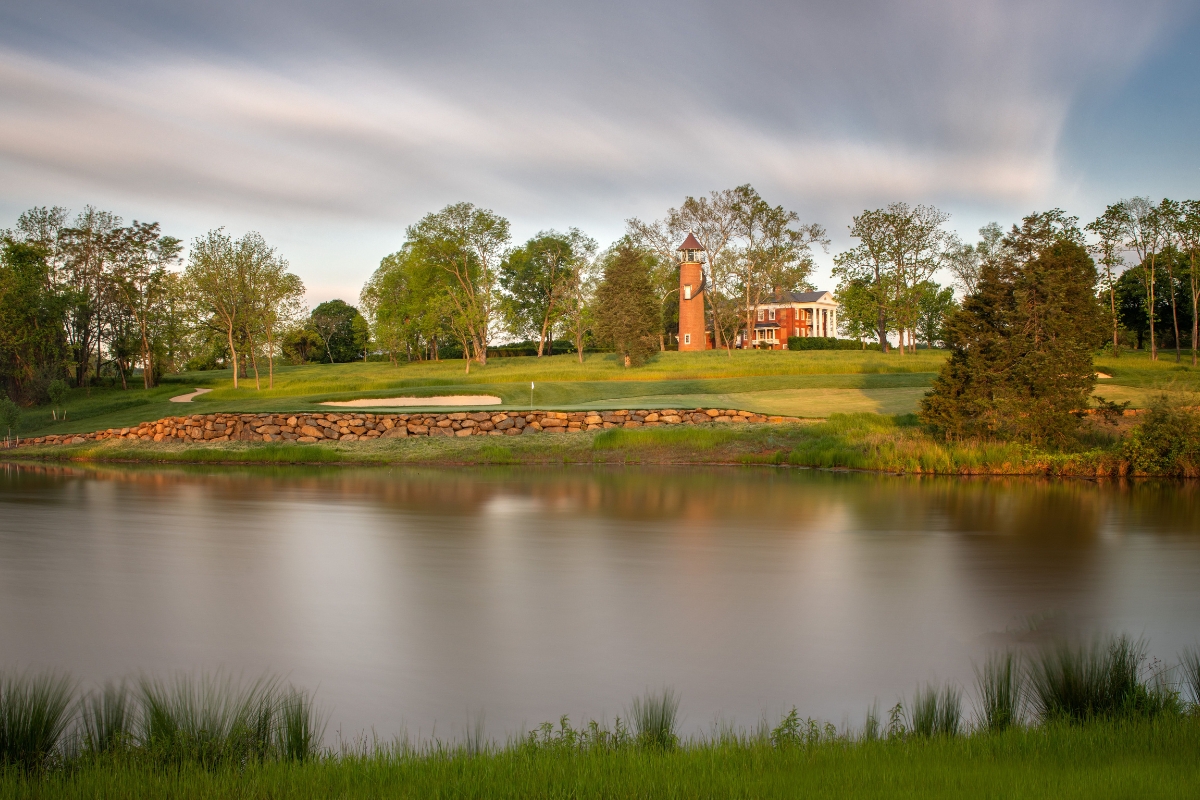 a body of water with a building and trees