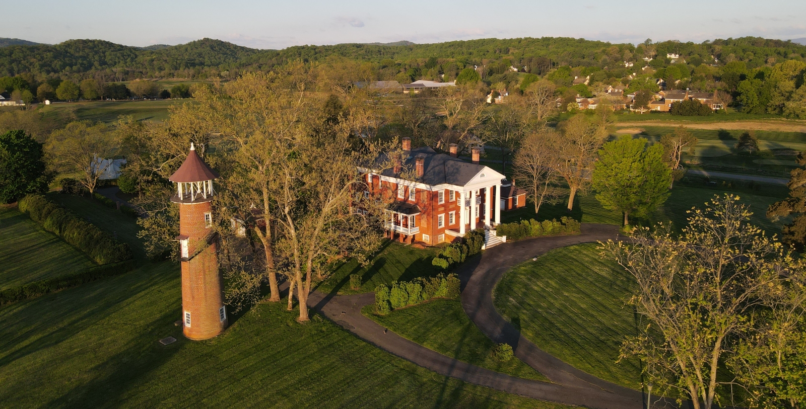 a building with a tower and trees