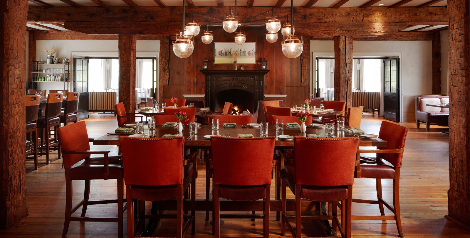 a room with a fireplace and tables