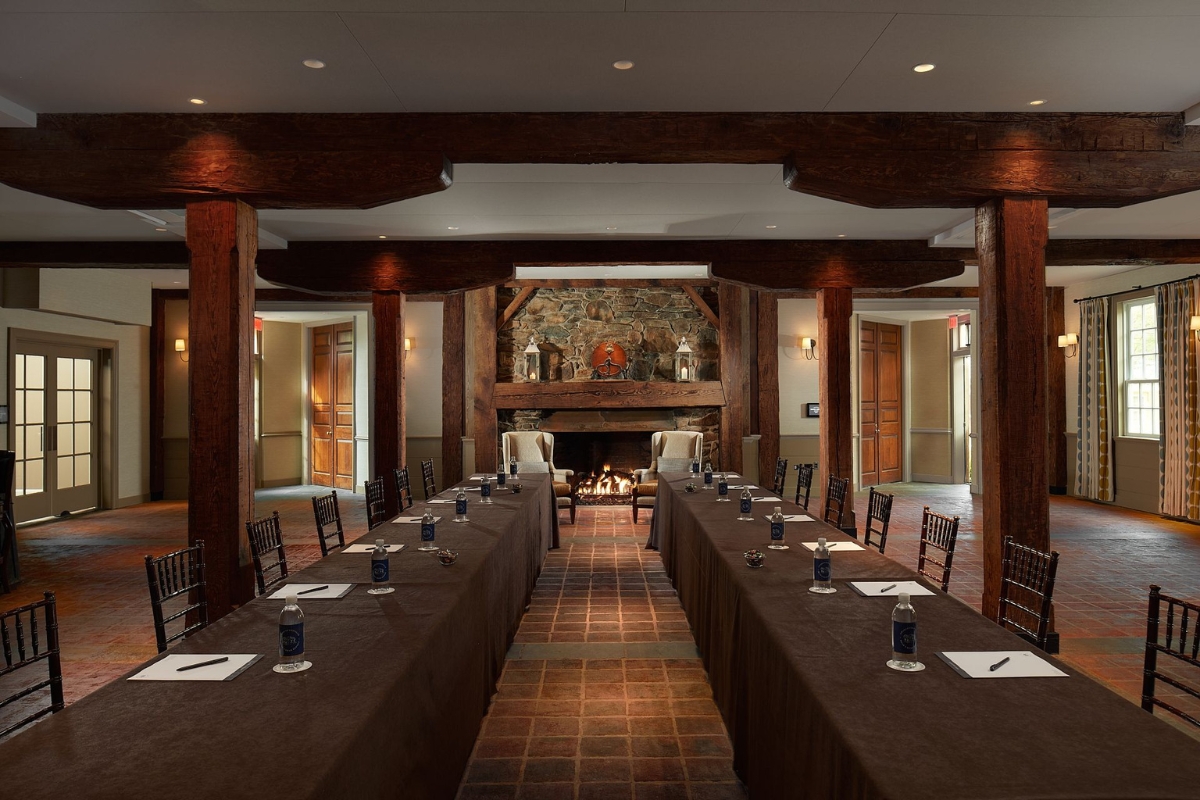 long table with brown tablecloths and blue candles on it