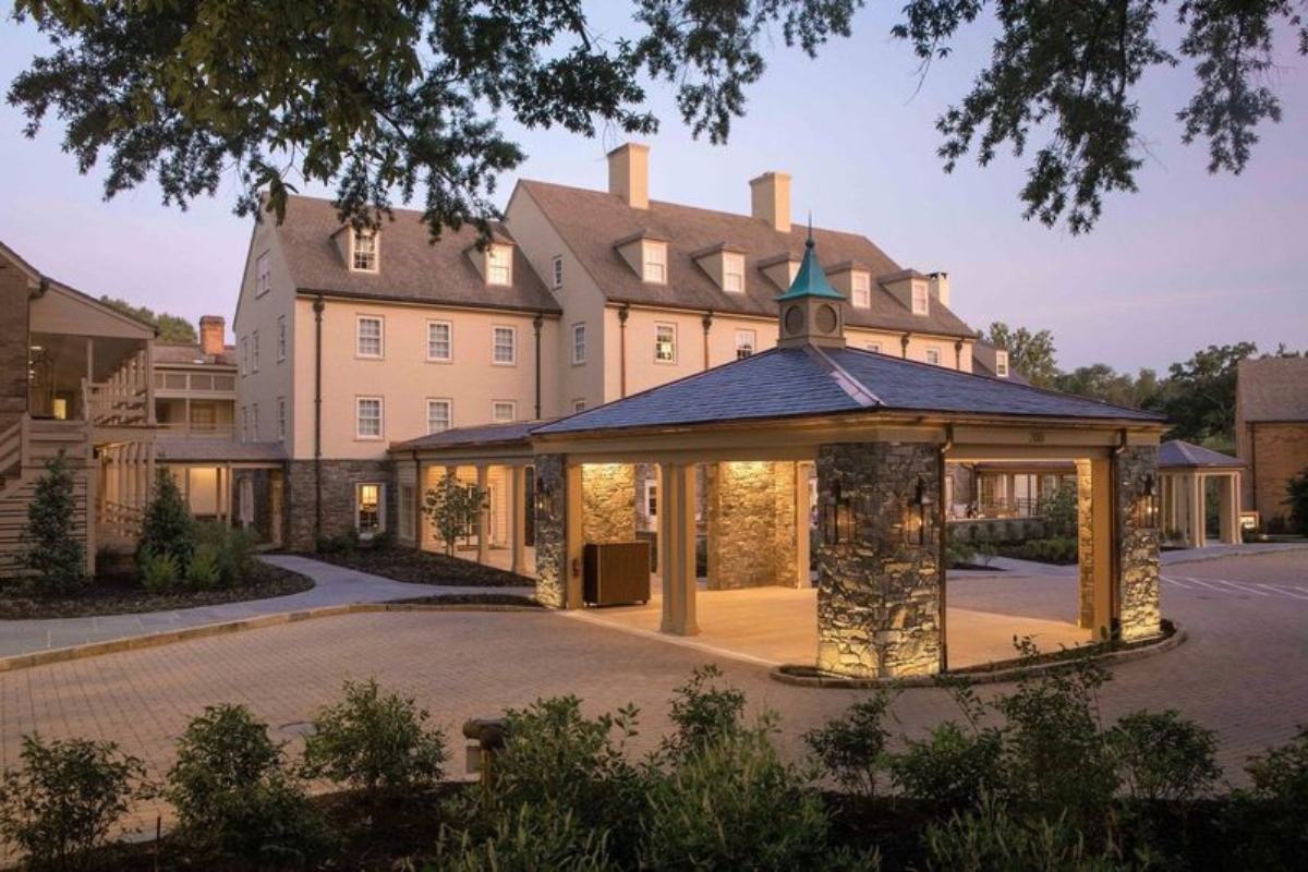 a building with a stone structure and a stone patio