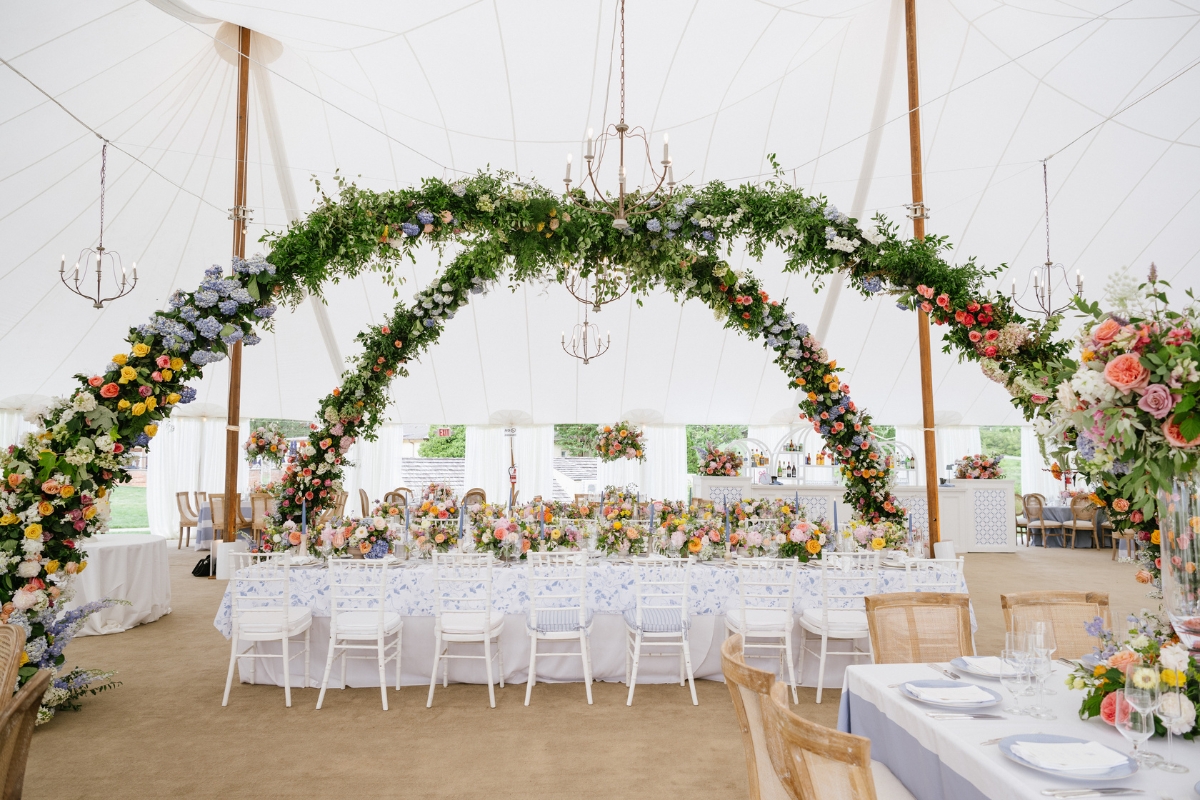 a table set up with flowers and a chandelier