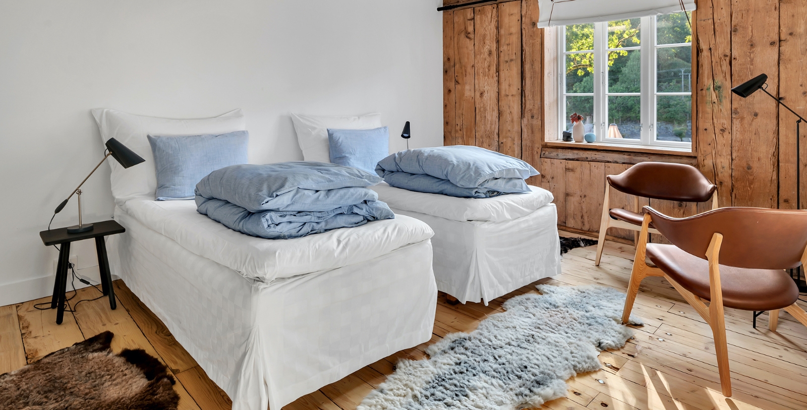 a room with two beds and a rug