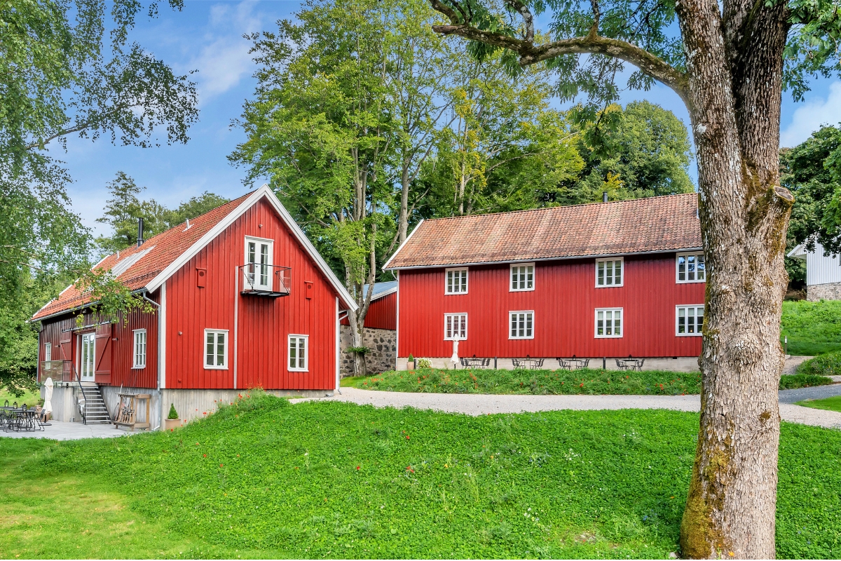 a red house with a tree in the background