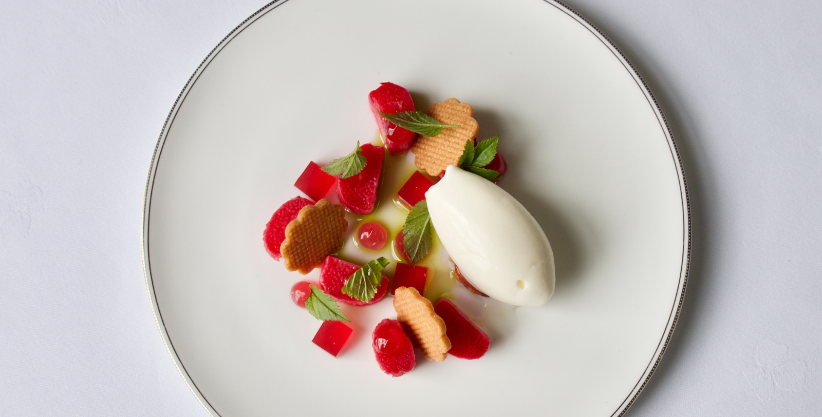 a plate of dessert with ice cream and fruit