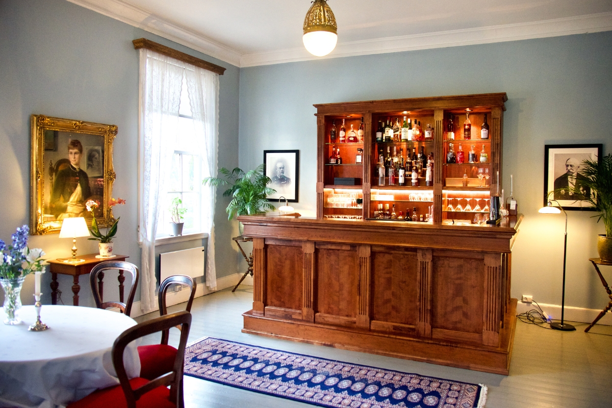 a room with a bar and a rug