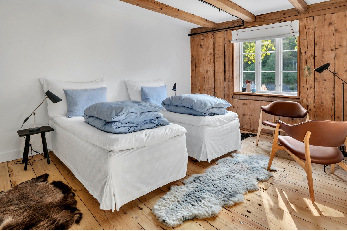 a room with two beds and a rug
