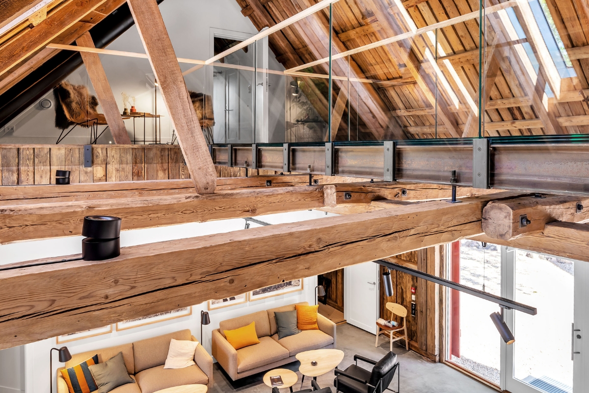 a room with a wood beam and a couch