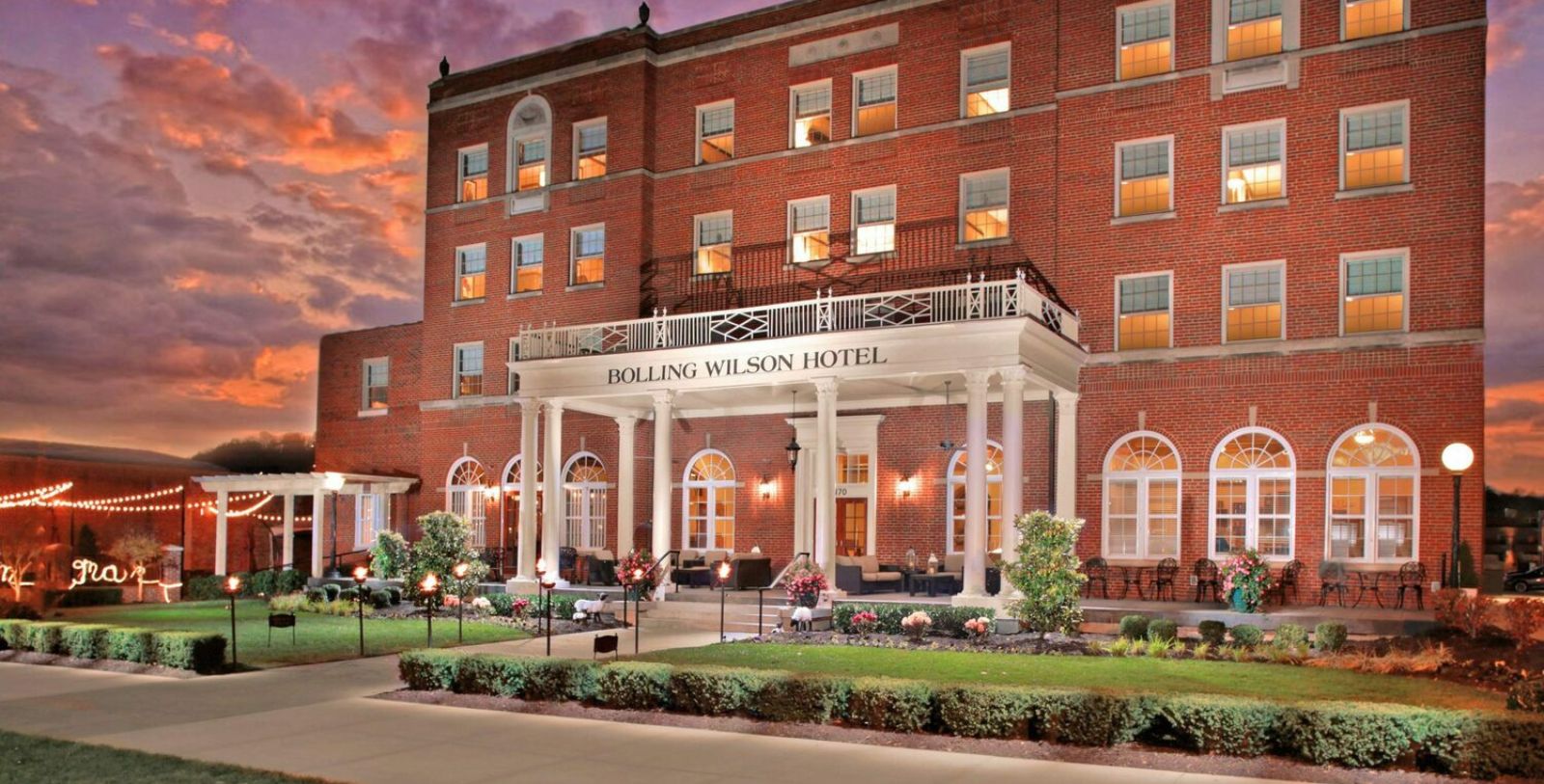a large brick building with a large porch