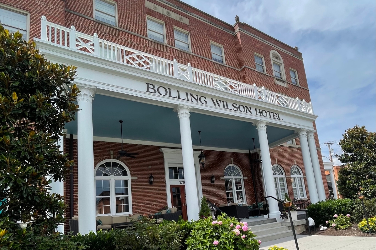 a building with white pillars and a sign
