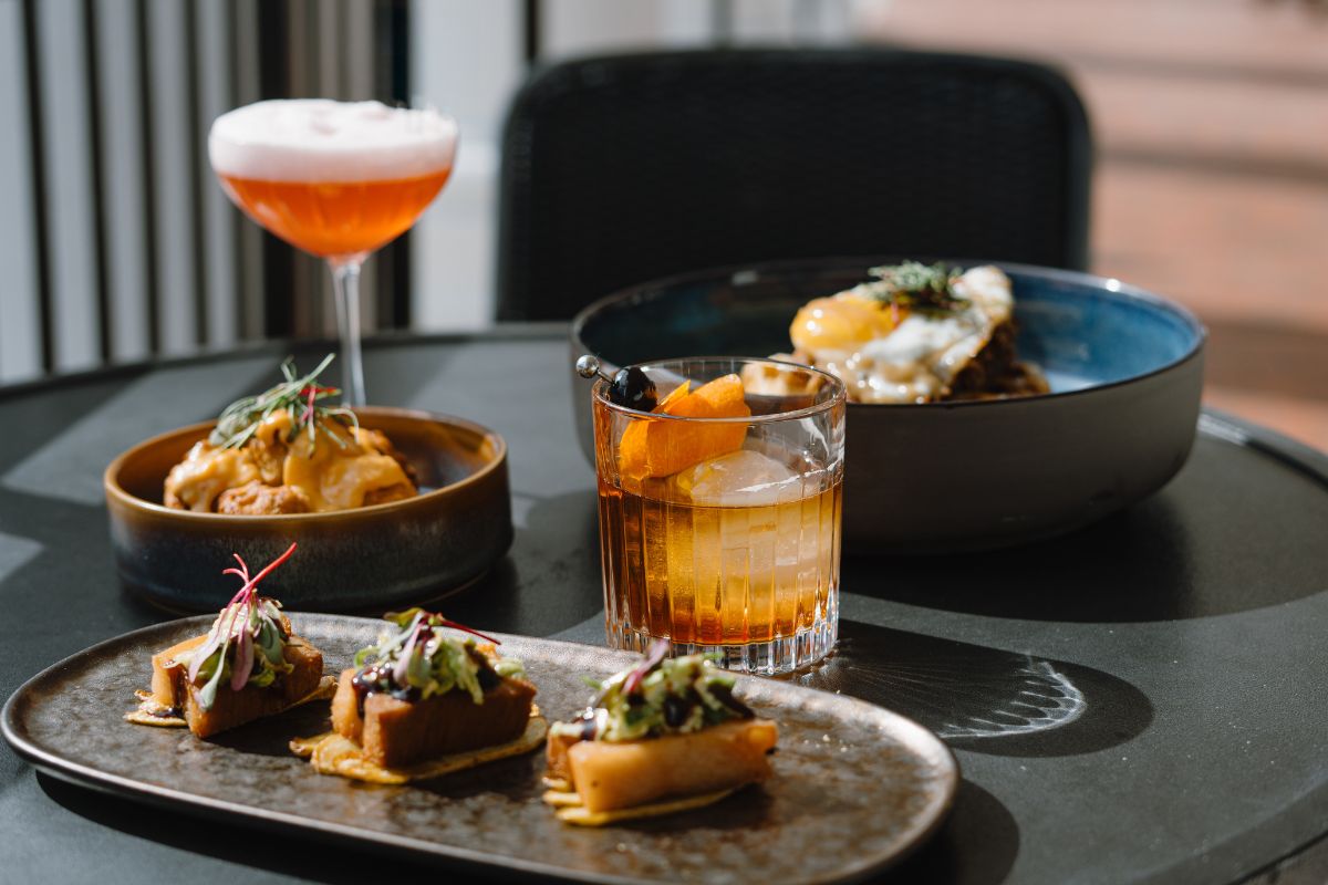 a table with plates of food and drinks