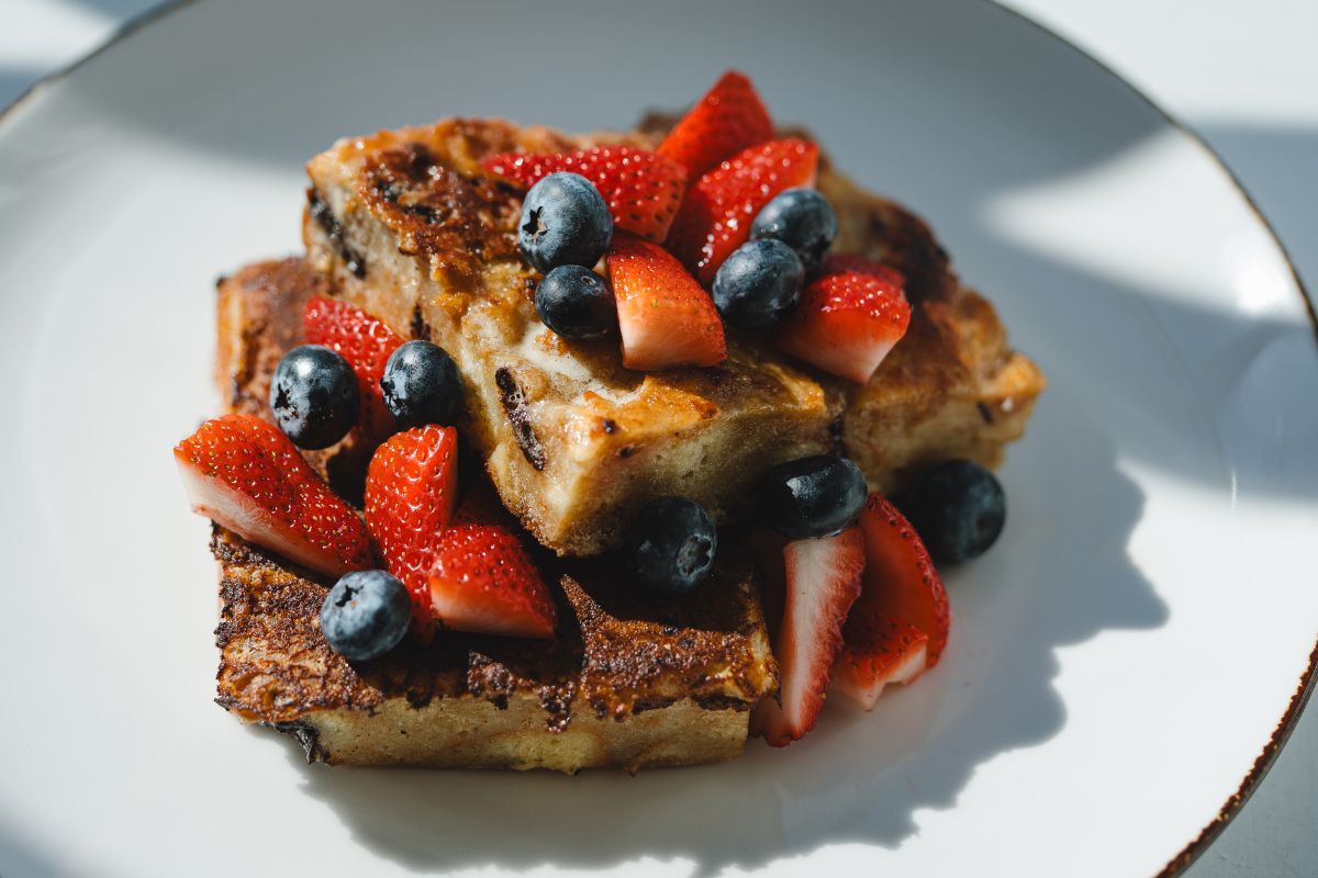a plate of food with strawberries and blueberries