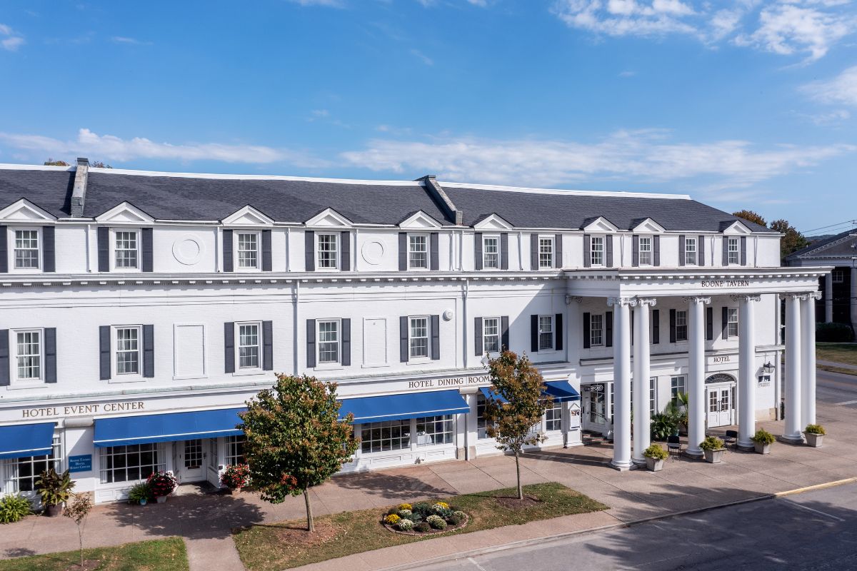 a building with columns and trees