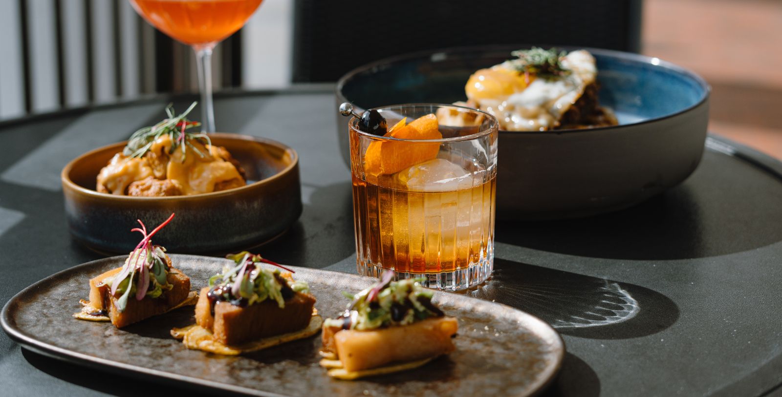 a table with plates of food and drinks