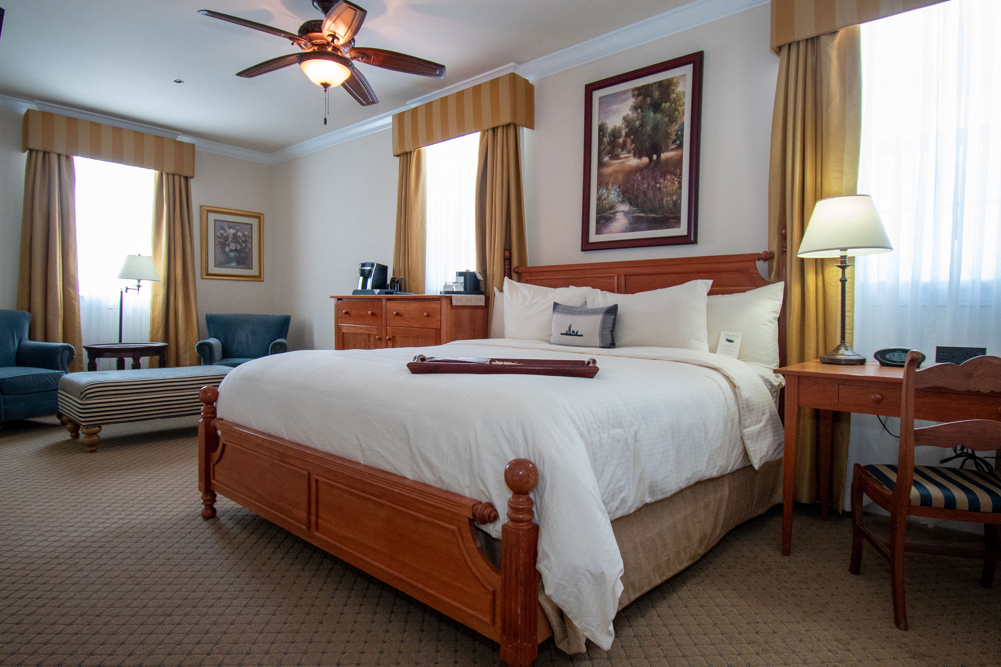 a room with a bed and a ceiling fan