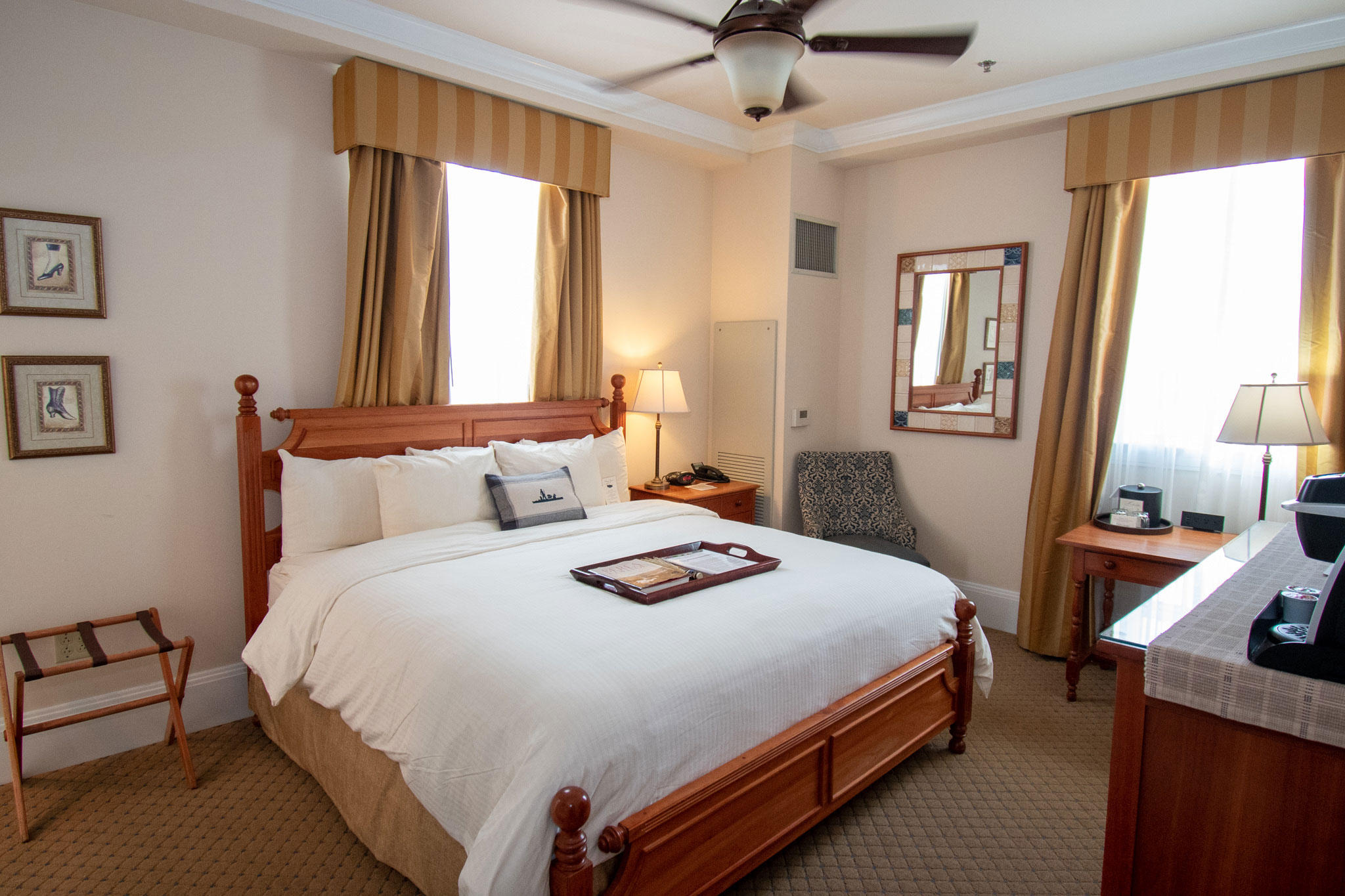 a room with a bed and a fan