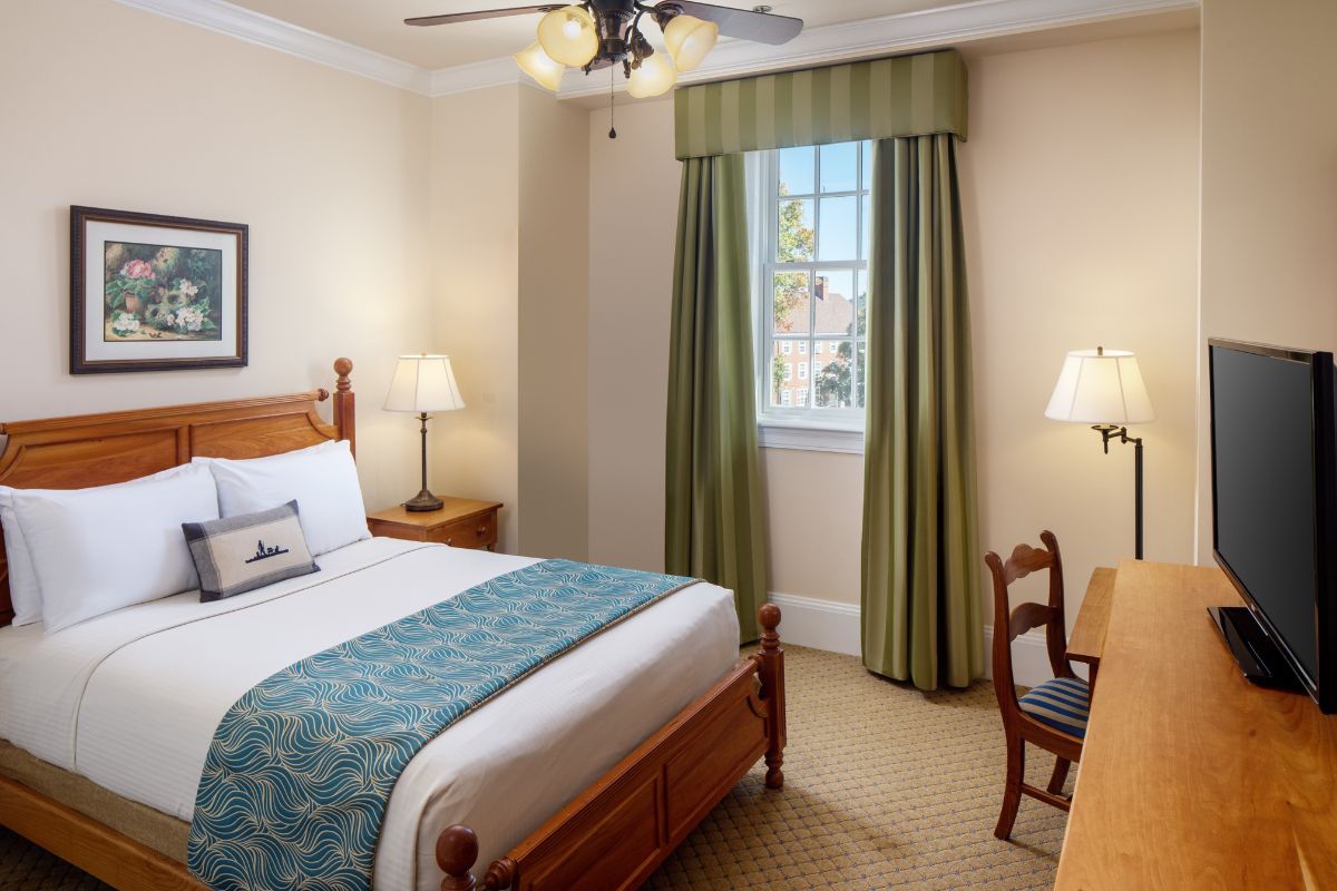 a bedroom with a bed and a fan