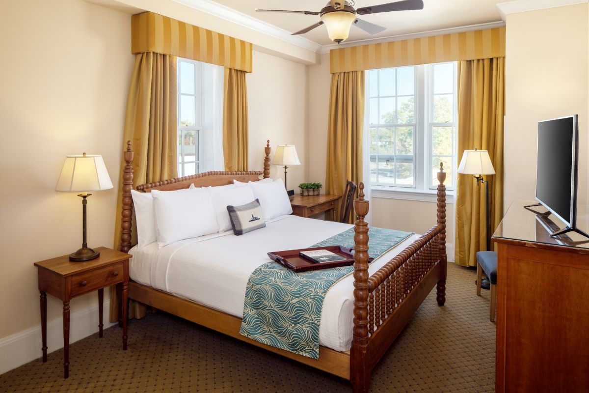 a room with a bed and a fan