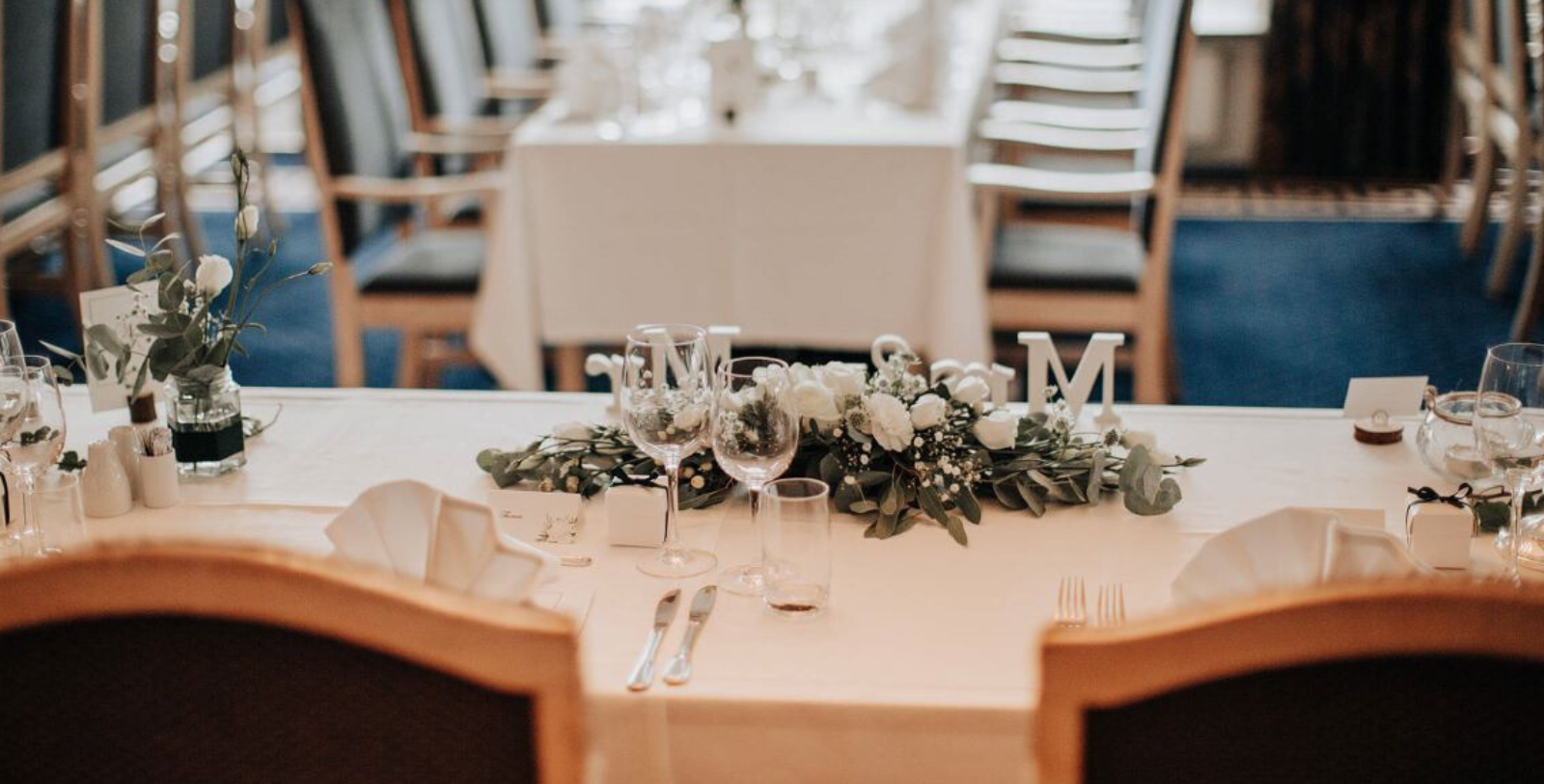 a table with glasses and flowers