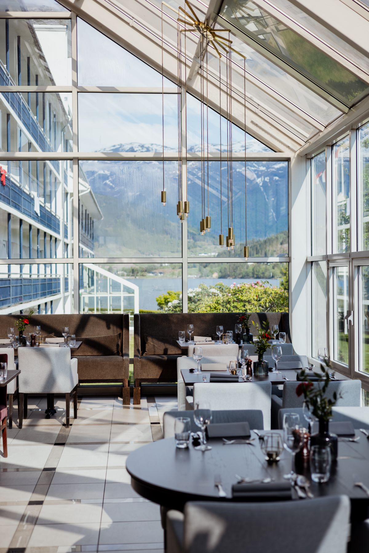 a restaurant with a view of the mountains and a lake
