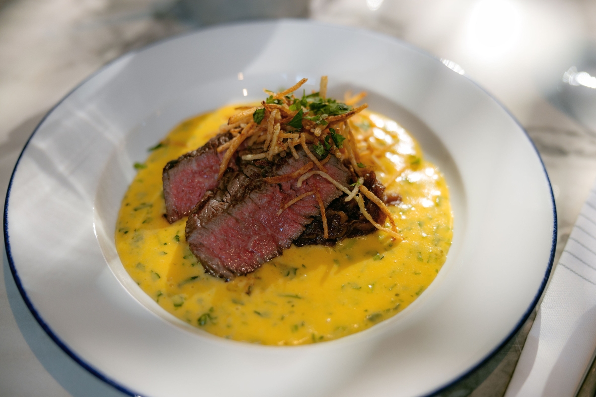 a plate of food with a piece of meat and cheese