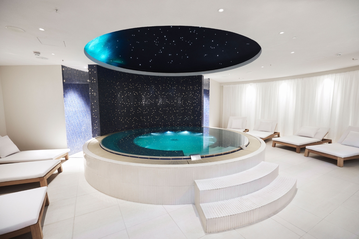 a indoor jacuzzi with a round pool