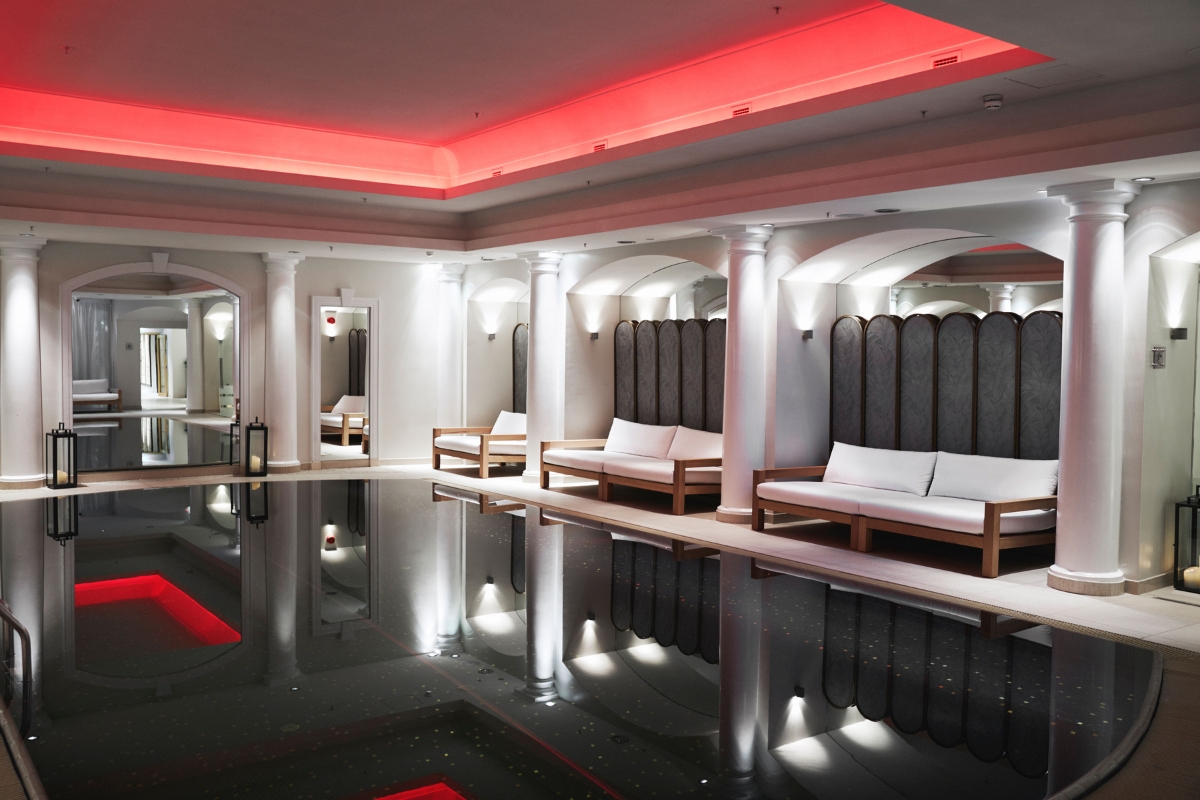a pool with benches and red lights