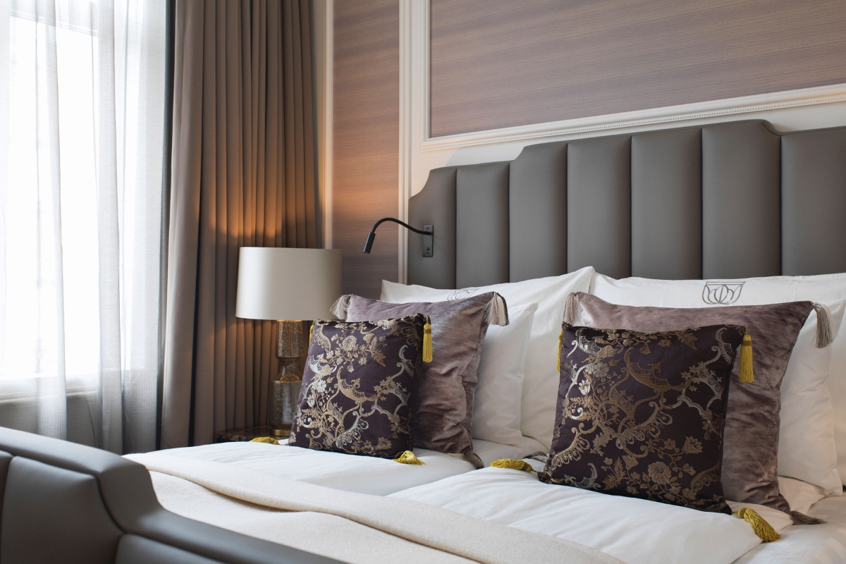 a bed with pillows and a lamp