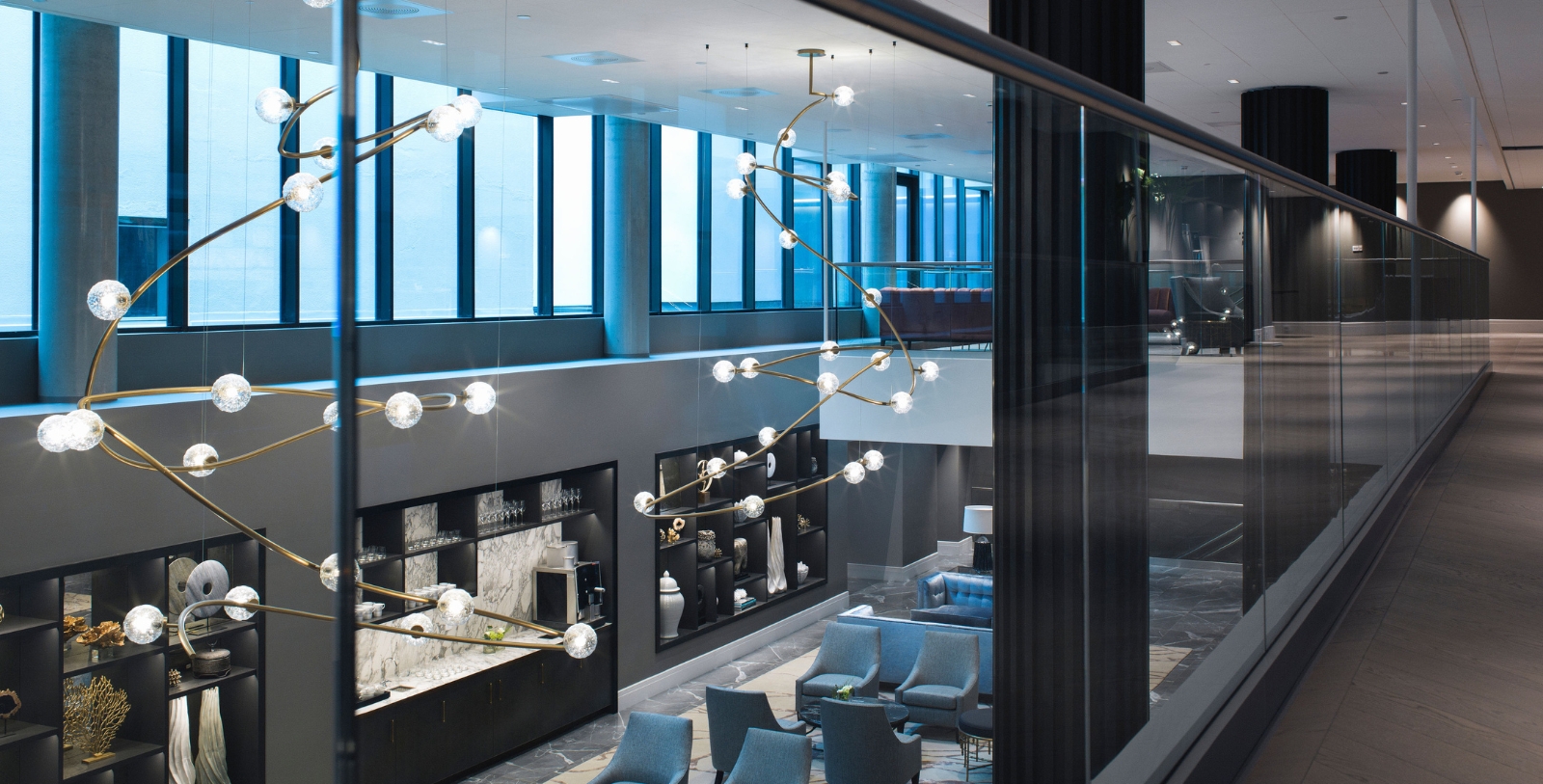 a room with a glass wall and a chandelier
