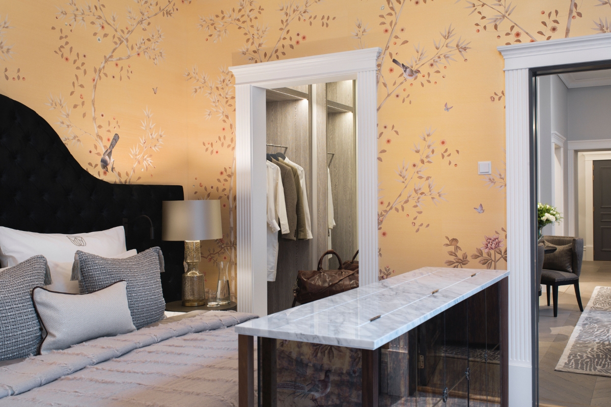 a bedroom with a mirror and a bed