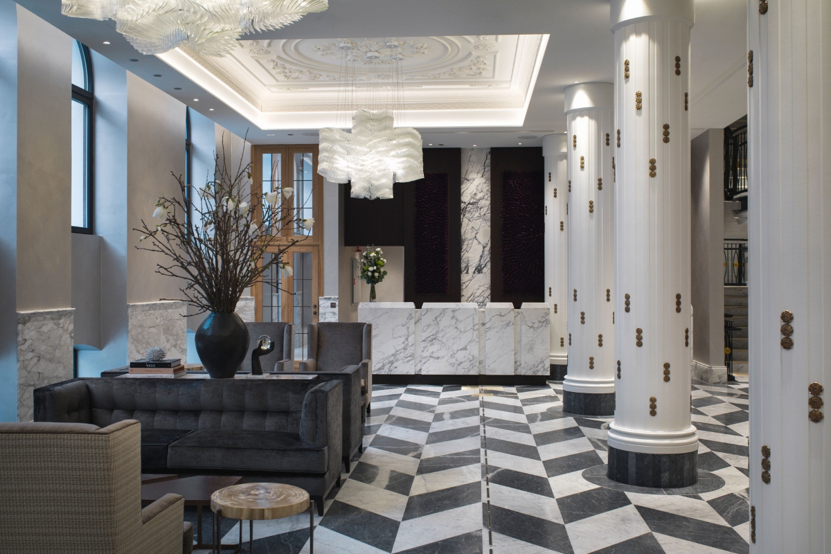 a lobby with marble columns and a black and white checkered floor