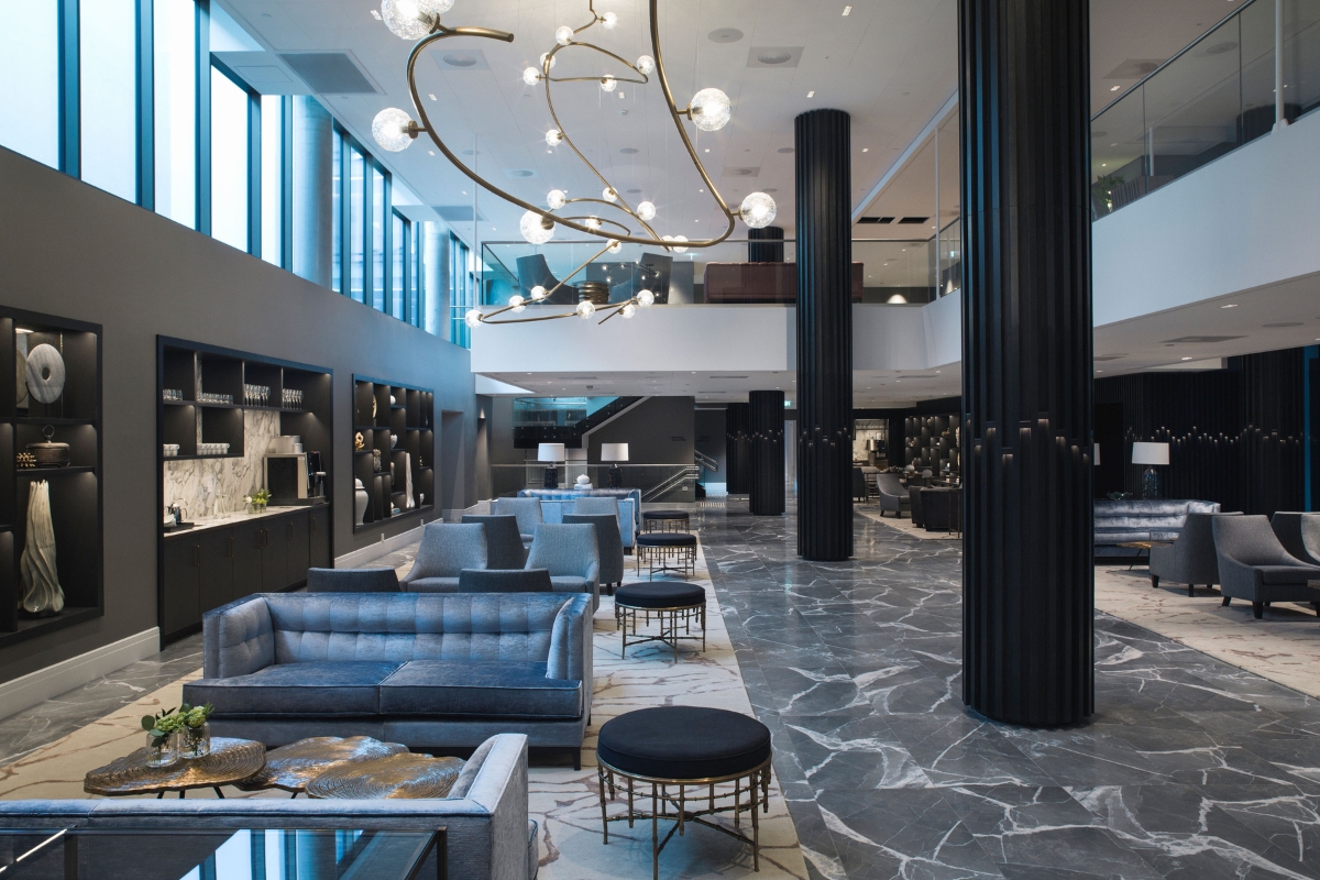 a large lobby with a chandelier and couches