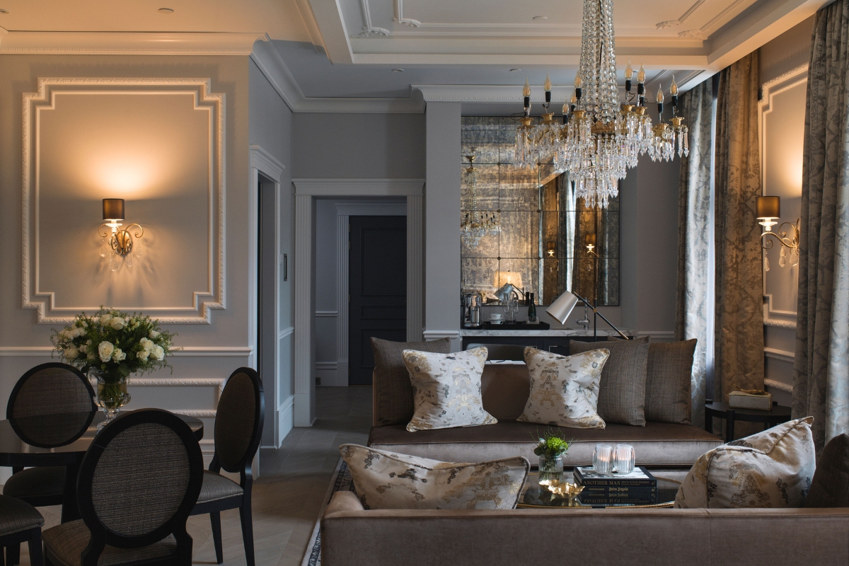 a living room with a chandelier and couches