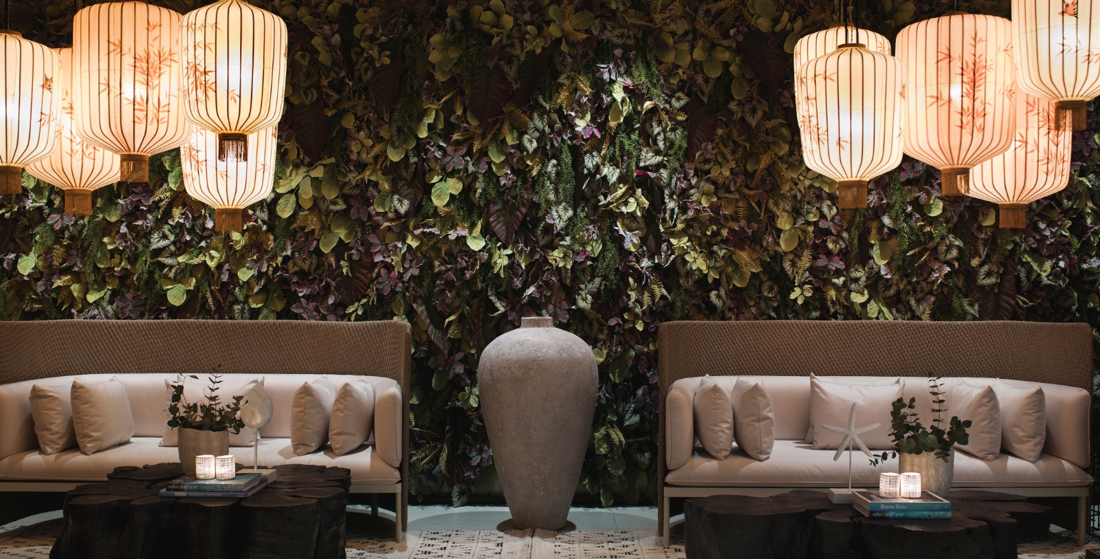 chairs in a room with plants and a vase