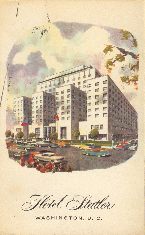 a large building with cars and people in front