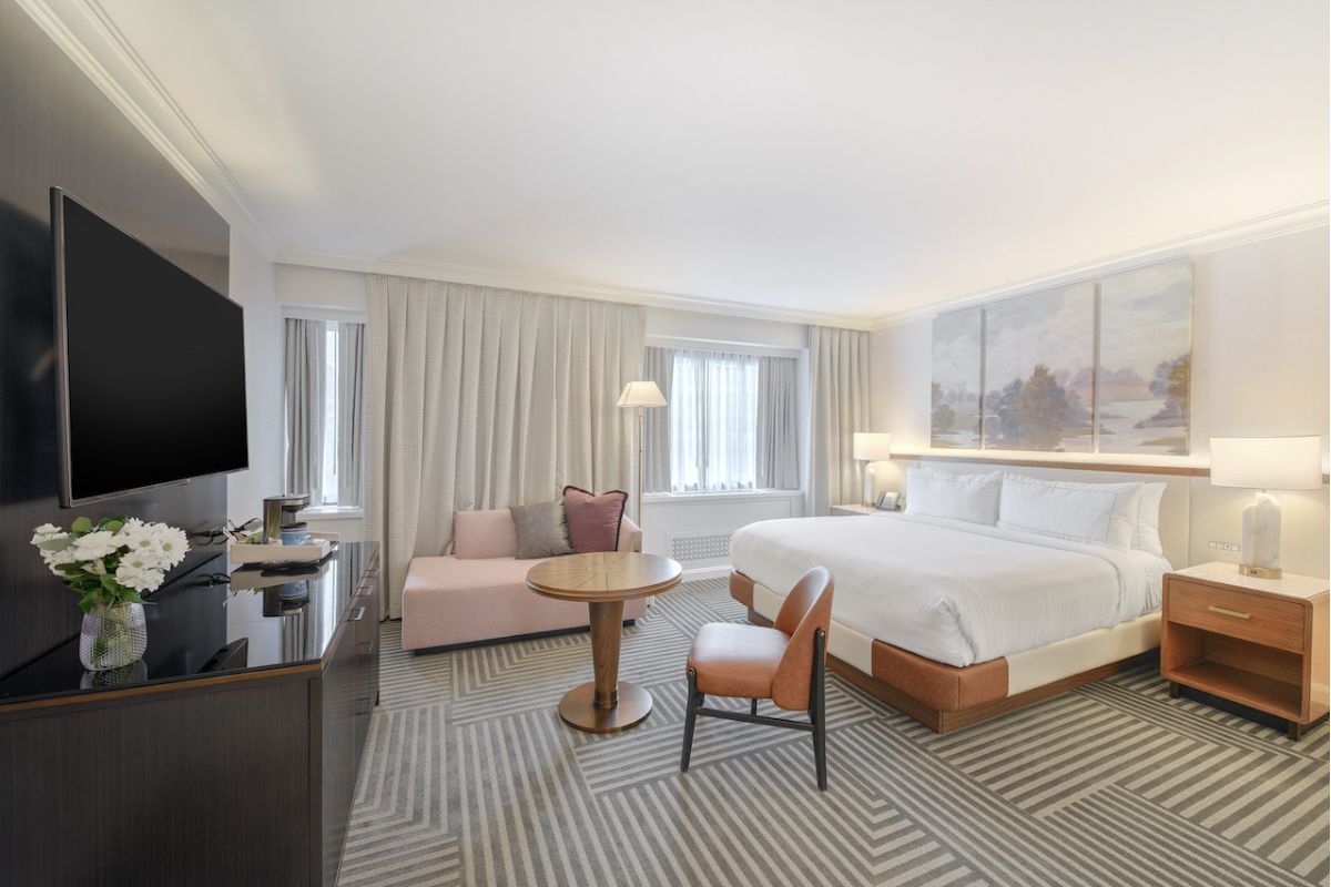 a room with a bed and a television