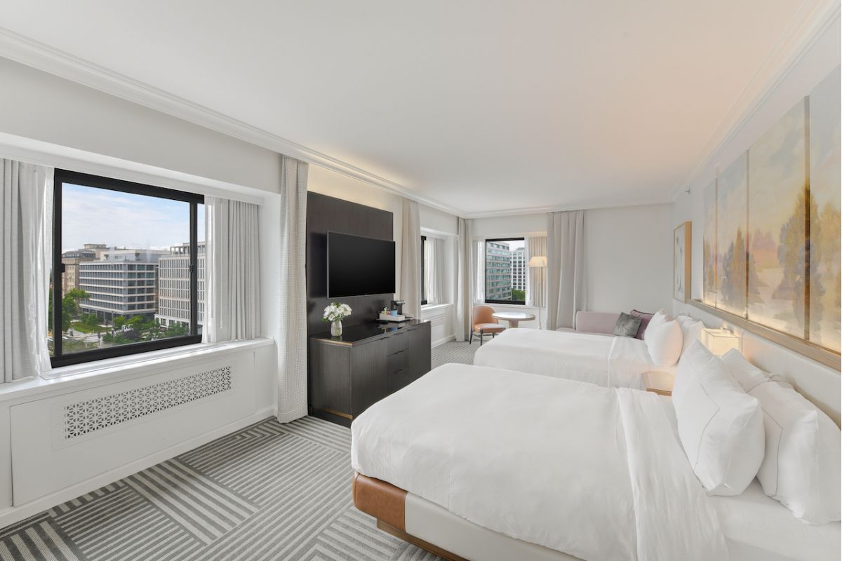 a room with two beds and a television