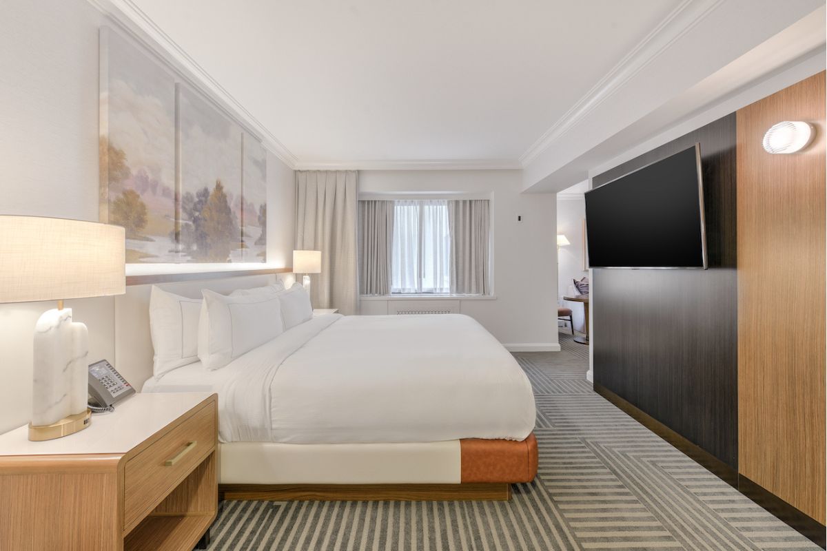 a room with a bed and a television