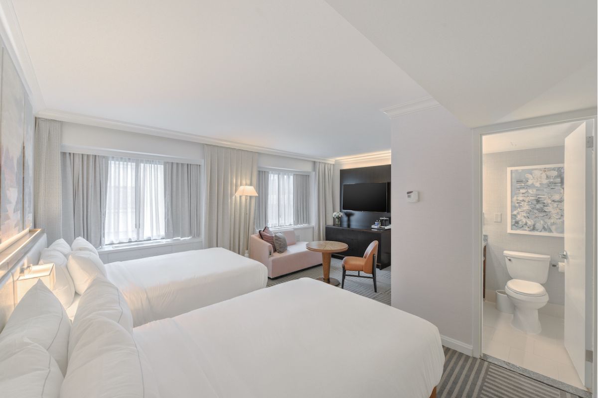 a room with two beds and a tv