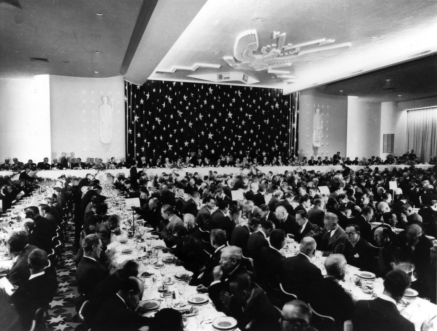 a large group of people sitting at a table