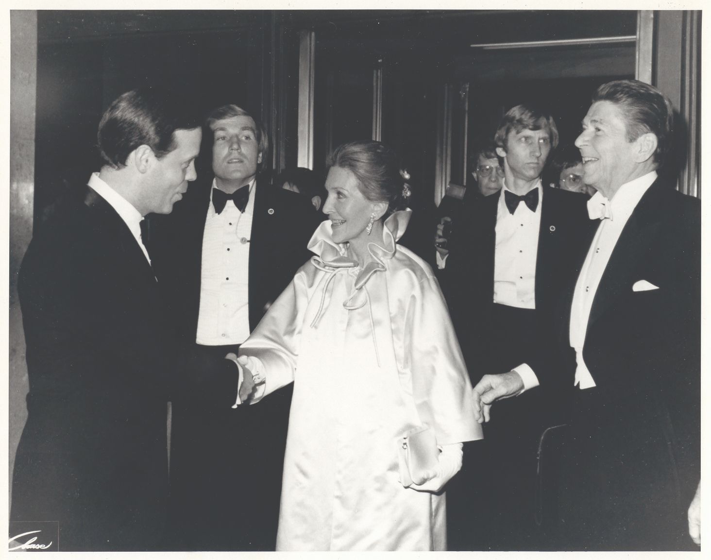 a group of people in suits
