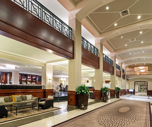 a large lobby with a large staircase and a large couch