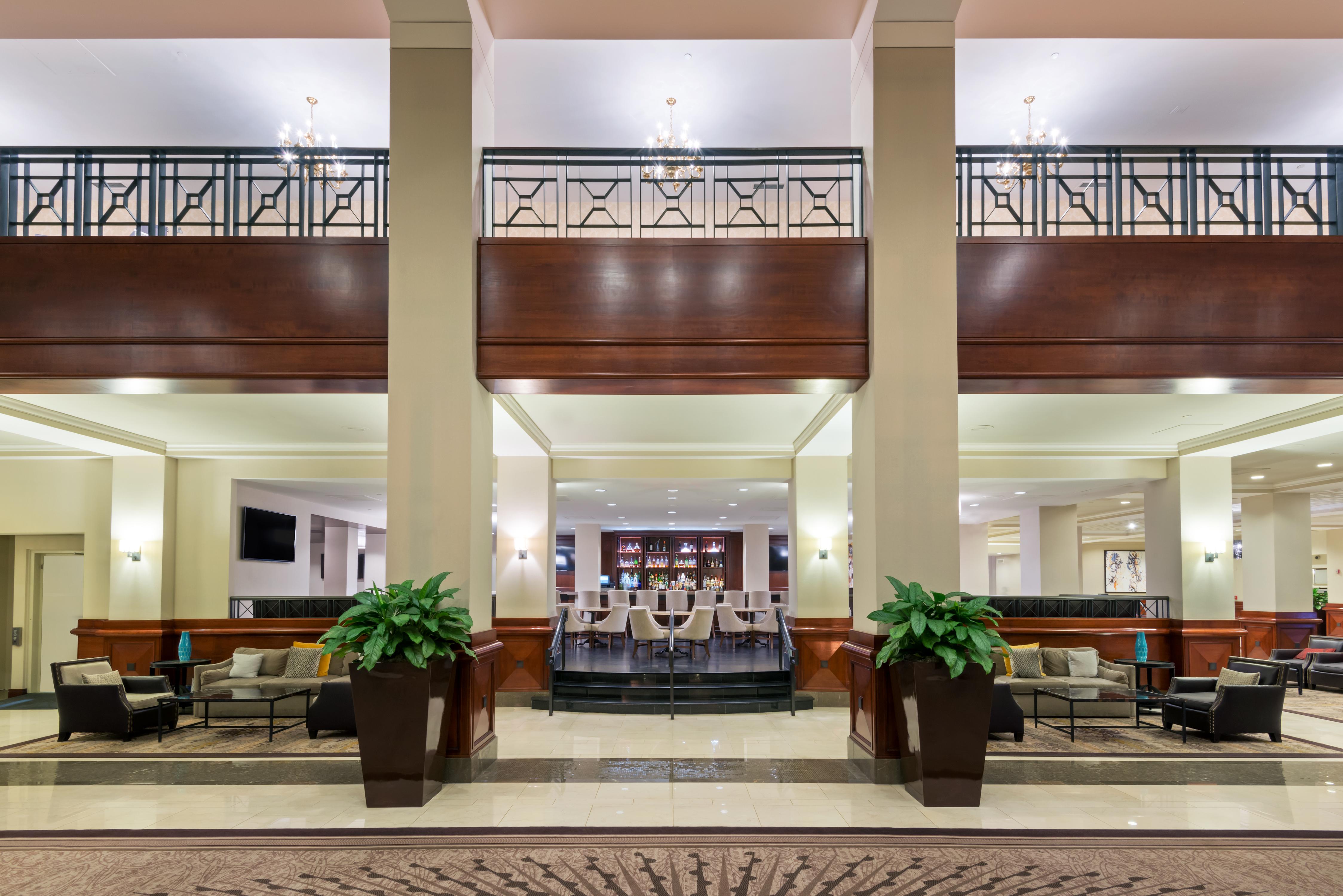 a large room with a large balcony and a large table and chairs