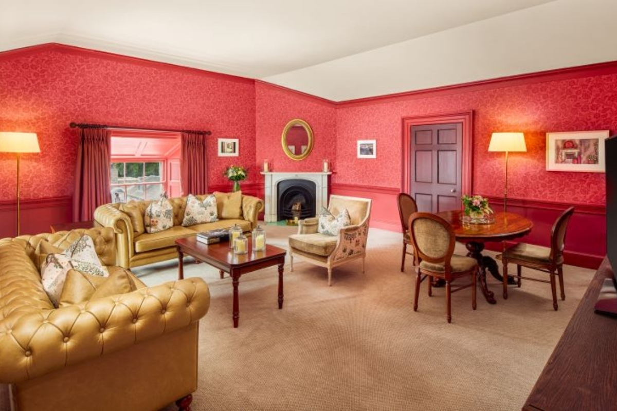 a living room with red walls and a fireplace
